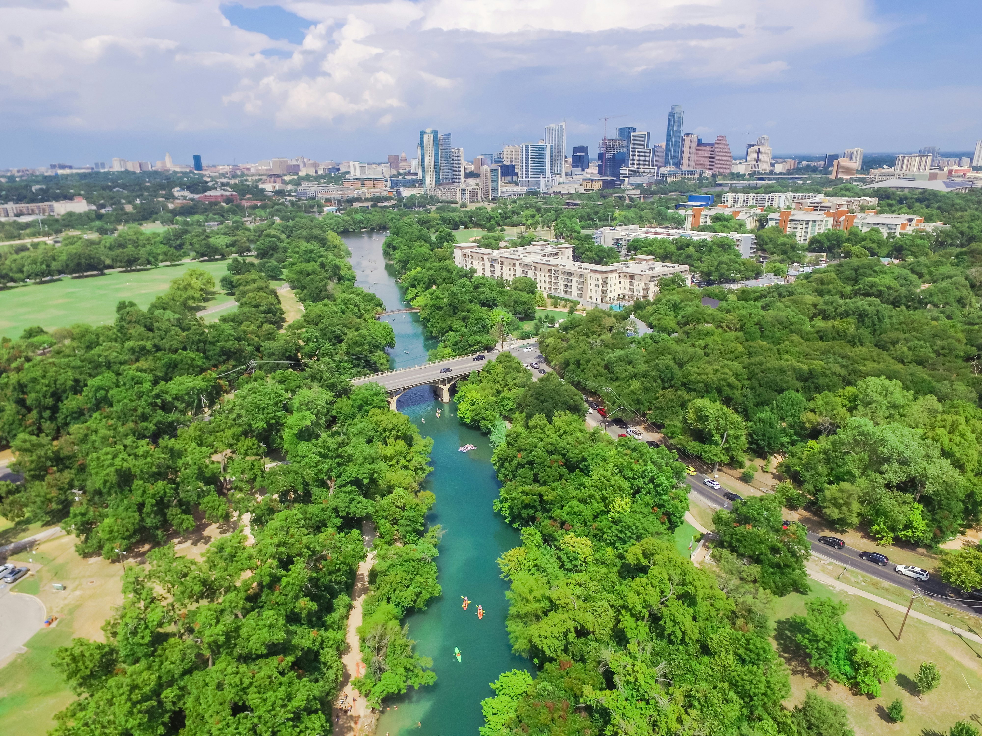 Aerial view Downtown from Barton Creek in Greenbelt at Zilker Metropolitan Park south Austin with summer blue cloud sky. Located at eastern edge of Hill Country, Austin the state capital of Texas, US.