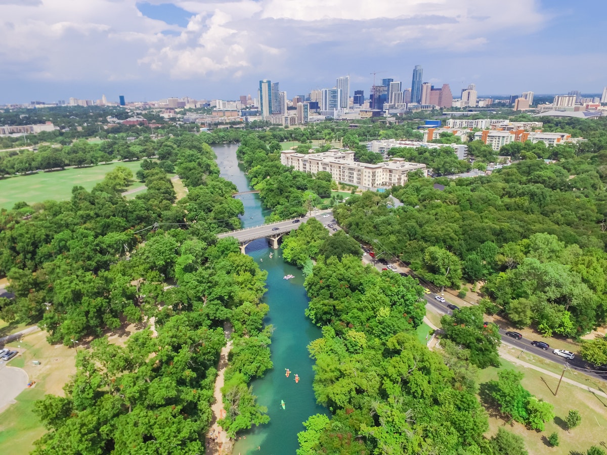 Aerial view Downtown from Barton Creek in Greenbelt at Zilker Metropolitan Park south Austin with summer blue cloud sky. Located at eastern edge of Hill Country, Austin the state capital of Texas, US.