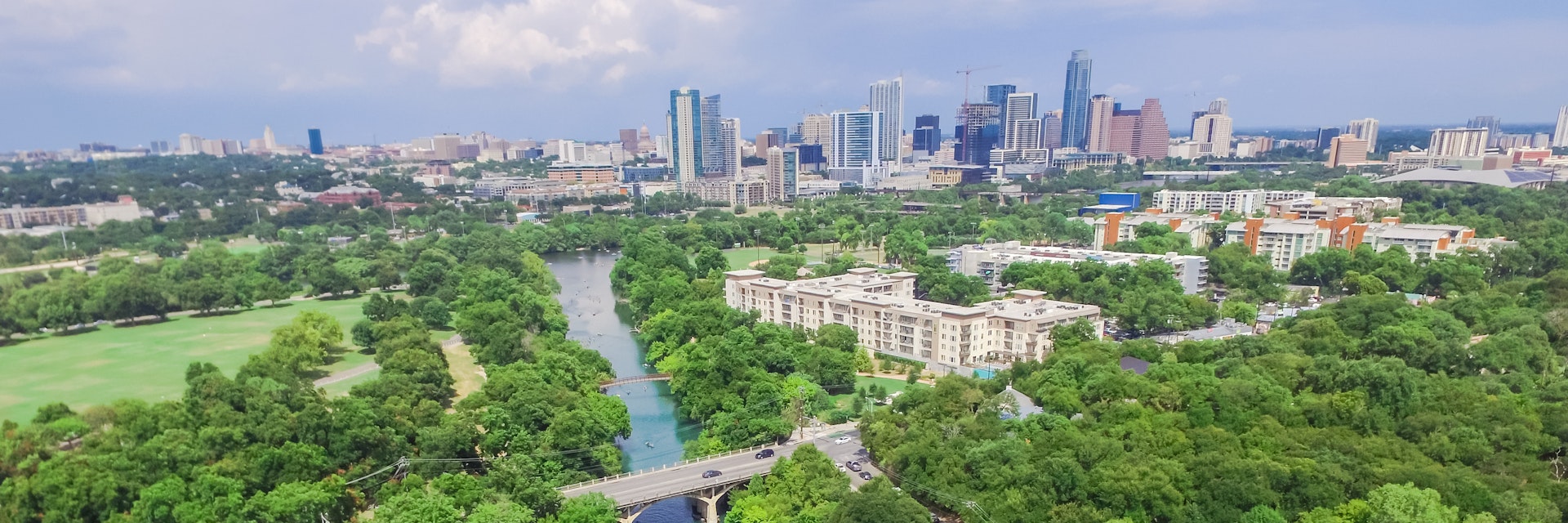 Aerial view Downtown from Barton Creek in Greenbelt at Zilker Metropolitan Park south Austin with summer blue cloud sky. Located at eastern edge of Hill Country, Austin the state capital of Texas, US.