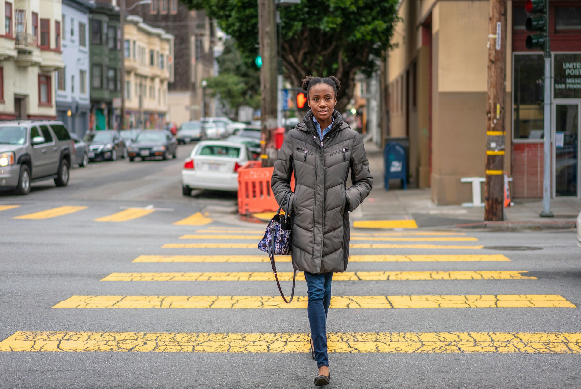 A woman on a crosswalk during winter in San Francisco, California