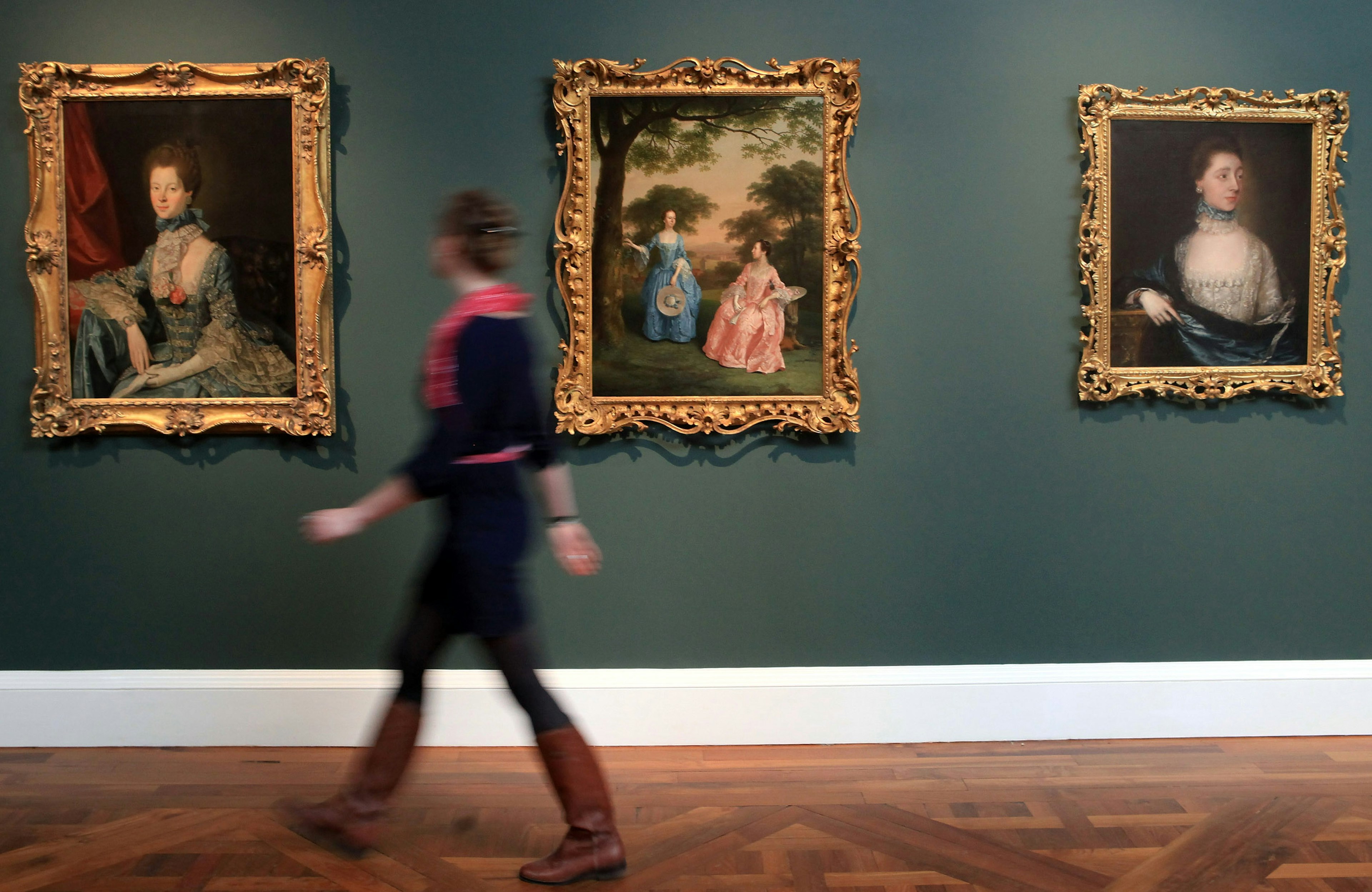 Lisa Hartung, museum volunteer and trainee curator, walks past painting recently hung at a preview of the new Holburne Museum ahead of its reopening on May 12, 2011 in Bath, England.