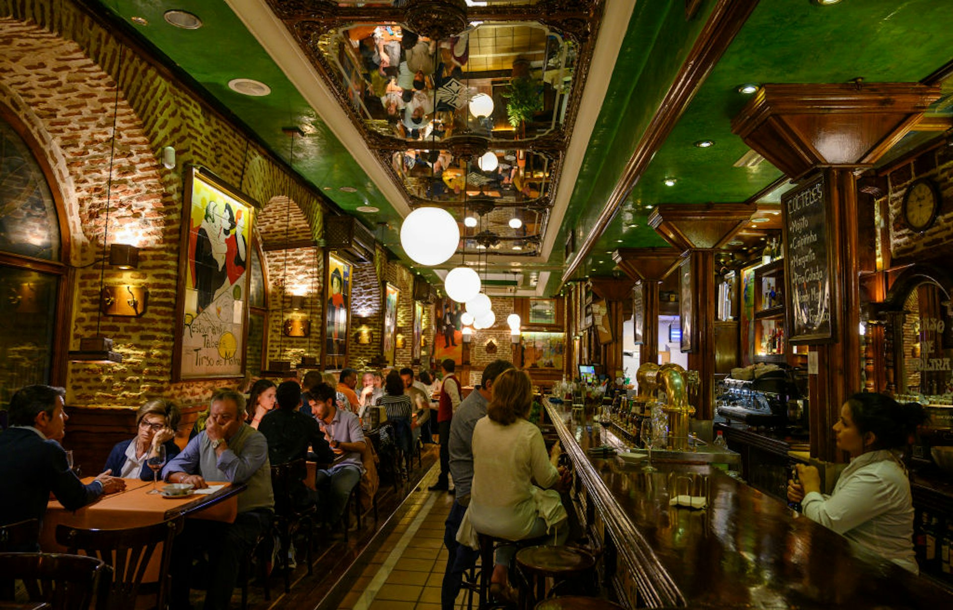 Patrons at dinner time in Tirso de Molina restaurant in Madrid, Spain