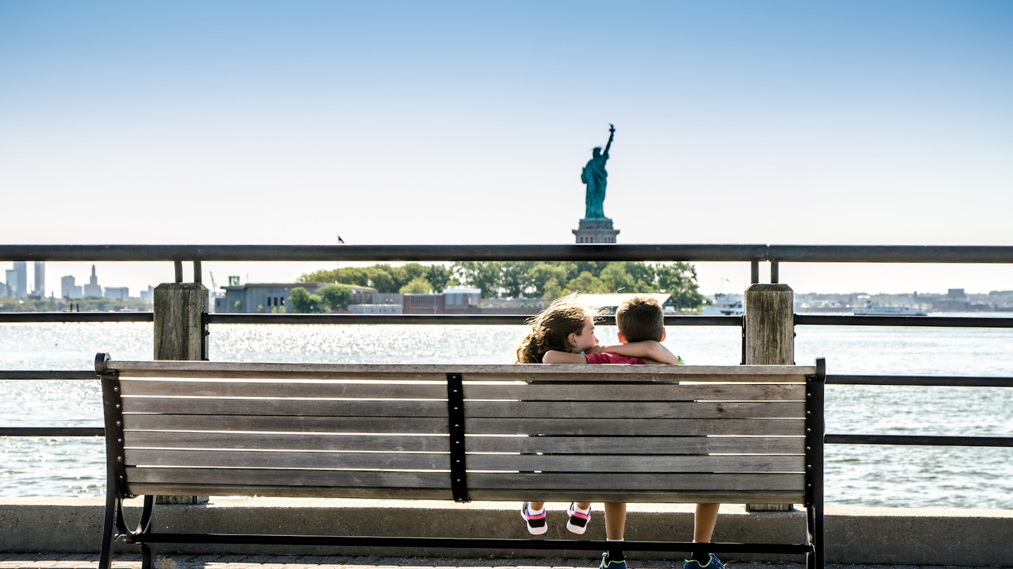 Two kids looking at Statue of Liberty from the Liberty State Park in Jersey city during summer day
1170418866