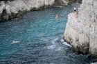 Young people jump from cliffs at the calanque de Sugiton in the Parc national des calanques in Marseille, southern France, on June 24, 2022. - Reservations for access to two creeks in Marseille from June 26, 2022 opened on June 23, 2022 on the website of the Calanques National Park, which is limiting the number of visitors to these fragile Mediterranean natural areas to 400 per day this summer, a first in France. (Photo by Nicolas TUCAT / AFP) (Photo by NICOLAS TUCAT/AFP via Getty Images)
1241498129
Horizontal