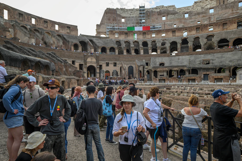 Tourists crowded on the floor of the Colosseum in Rome