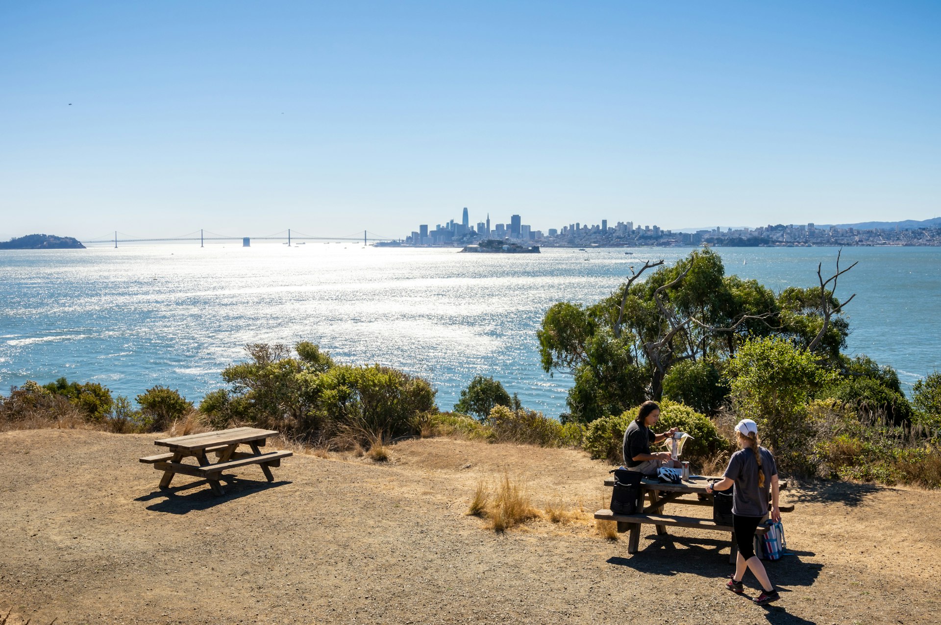 Tourists enjoying a picnic in Angel Island with the view of Alcatraz Island and San Francisco
