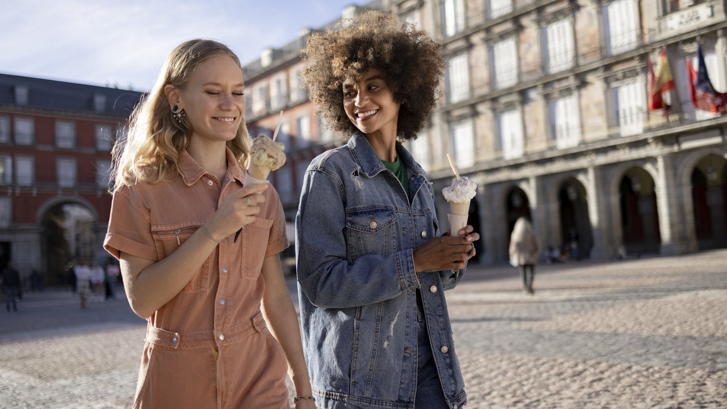 Small diverse group of female friends walking around the city of Madrid, bonding and having fun together and enjoying the ice cream
1350455026
