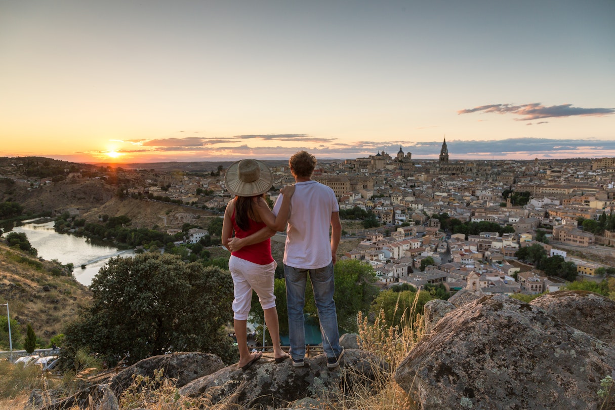 Spain, Castile La Mancha, Toledo. Adult couple of tourists looking at the city at sunset from a lookout
1364380908