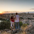 Spain, Castile La Mancha, Toledo. Adult couple of tourists looking at the city at sunset from a lookout
1364380908
