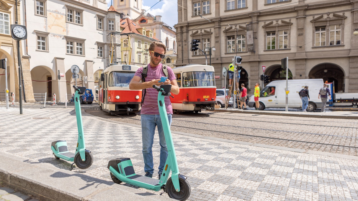 Photo series of young man tourist renting an electric scooter in the city centre to move around ecologically and practically. He uses a mobile phone activating an app. Prague, Czech Republic
1403721953