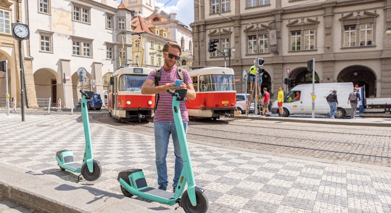 Photo series of young man tourist renting an electric scooter in the city centre to move around ecologically and practically. He uses a mobile phone activating an app. Prague, Czech Republic
1403721953