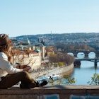 middle aged traveller woman in white sweatshirt in Prague Czech Republic enjoying promenade.
1443291755