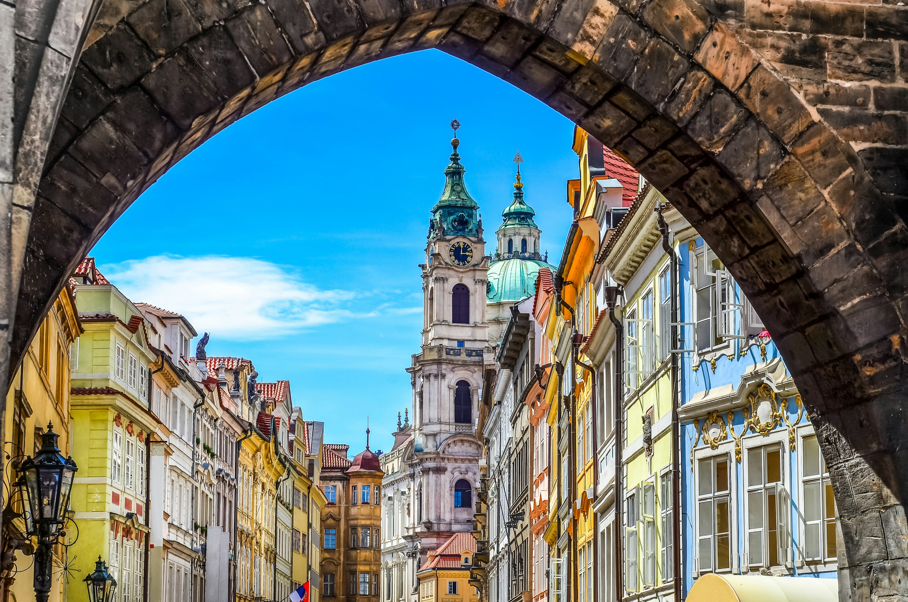 Pastel-colored old buildings viewed through an archway