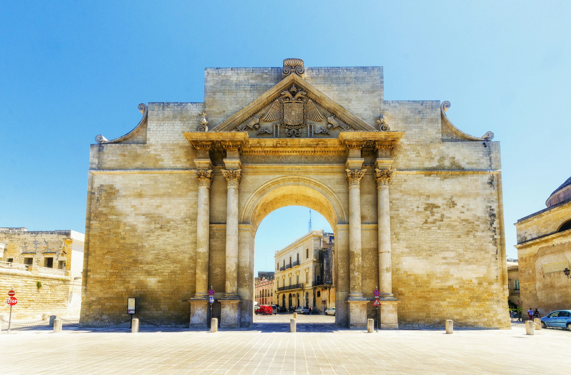 A vast ornate town gate in a city square