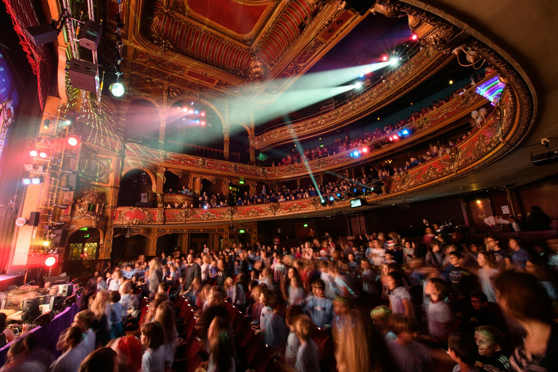 School children get out of their seats to dance during the finale of a performance of the traditional pantomime "Sleeping Beauty" at the Hackney Empire.