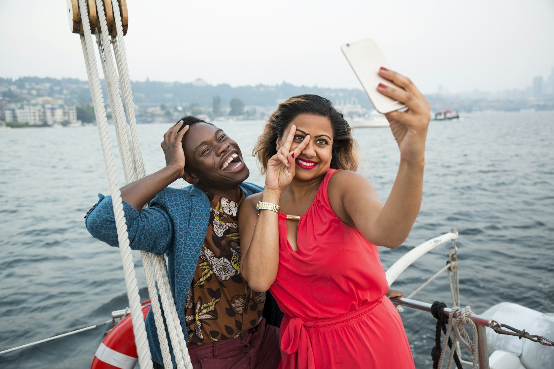 Two friends pose for a selfie on the back of a ferry in Seattle