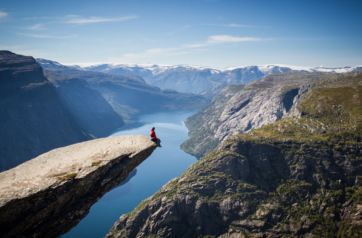 Sitting on Trolltunga rock overlooking the fjord.