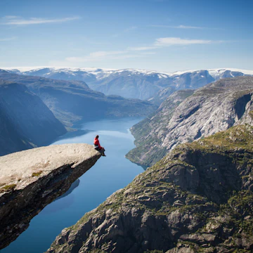 Sitting on Trolltunga rock overlooking the fjord.