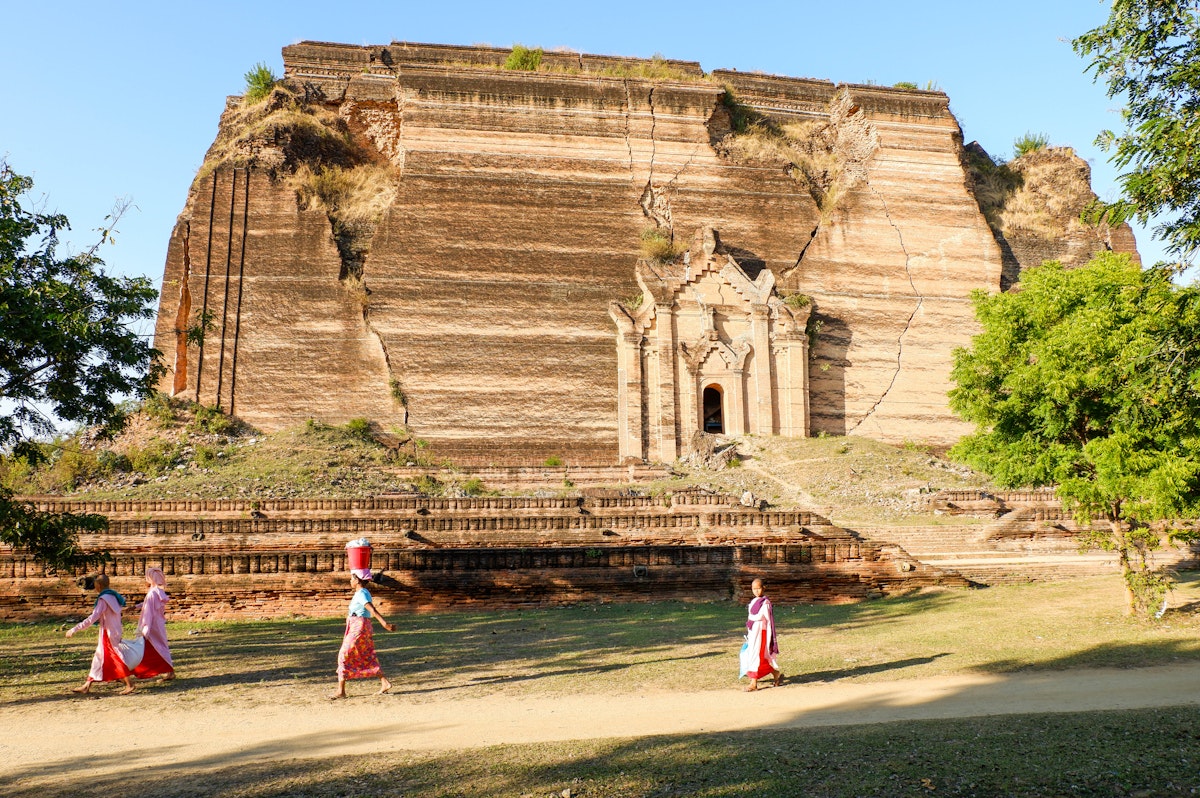 Nuns pass by the enormous Mingun Paya temple.