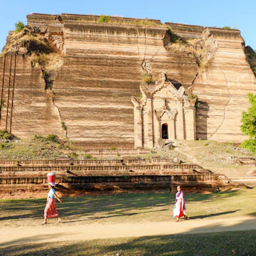 Nuns pass by the enormous Mingun Paya temple.