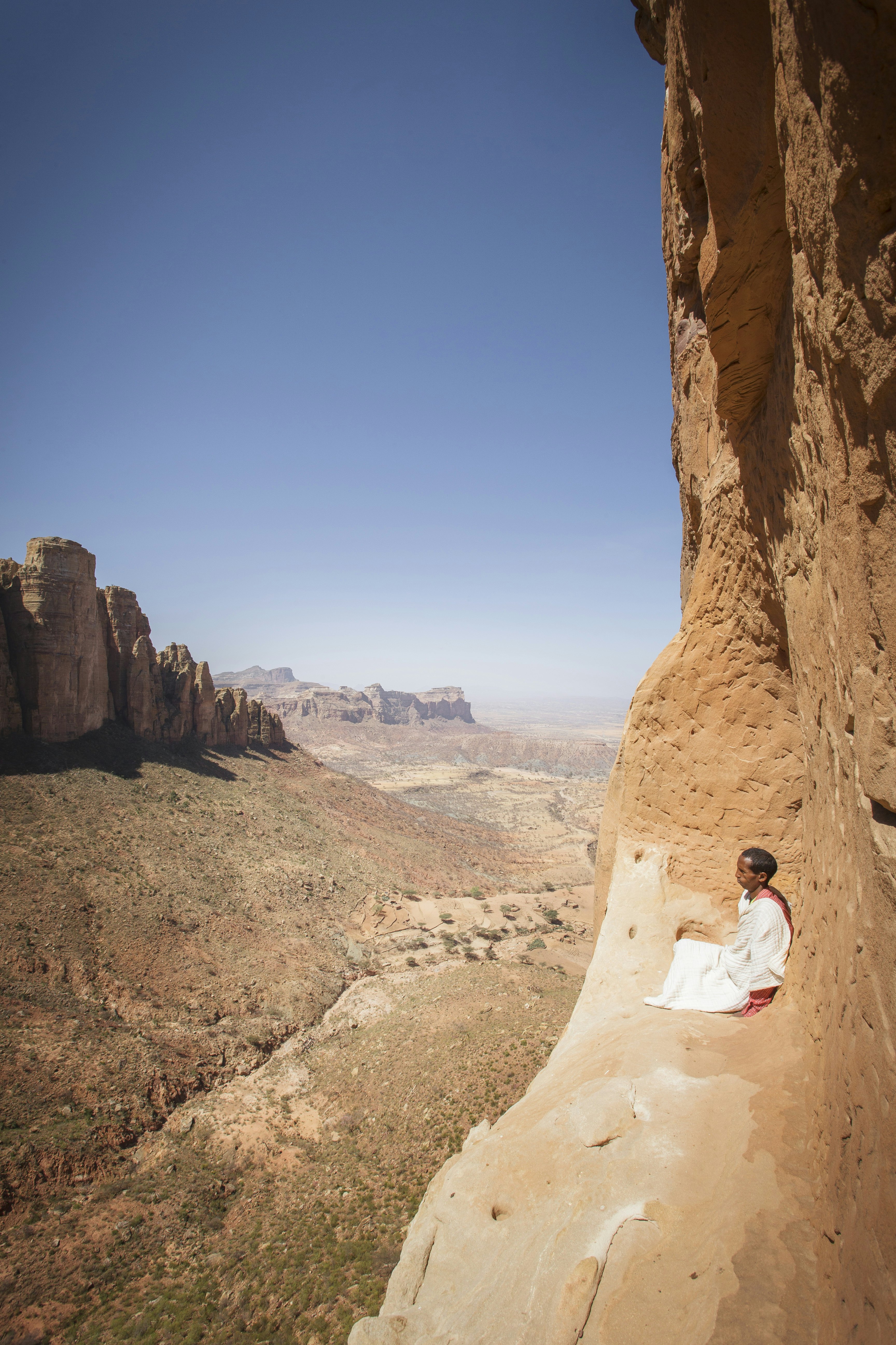 Lonely Planet Traveller Magazine, Issue 66, Ethiopia, In the beginning
Priest sitting on ledge outside Abuna Yemata Guh cave church.