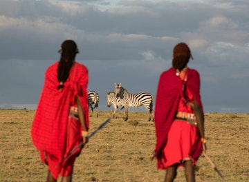 Maasai tribesmen in the Maasai Mara National Park. Kenya. Africa.