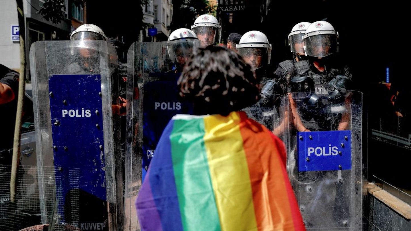 TOPSHOT - A participant faces riot policemen wearing a rainbow flag during a Pride march in Istanbul, on June 26, 2022. - Turkish police forcibly intervened in a Pride march in Istanbul, detaining dozens of demonstrators and an AFP photographer, AFP journalists on the ground said. The governor's office had banned the march around Taksim Square in the heart of Istanbul but protesters gathered nearby under heavy police presence earlier than scheduled. (Photo by KEMAL ASLAN / AFP) (Photo by KEMAL ASLAN/AFP via Getty Images)
1241549679
homosexuality, demonstration, politics, gender, Horizontal