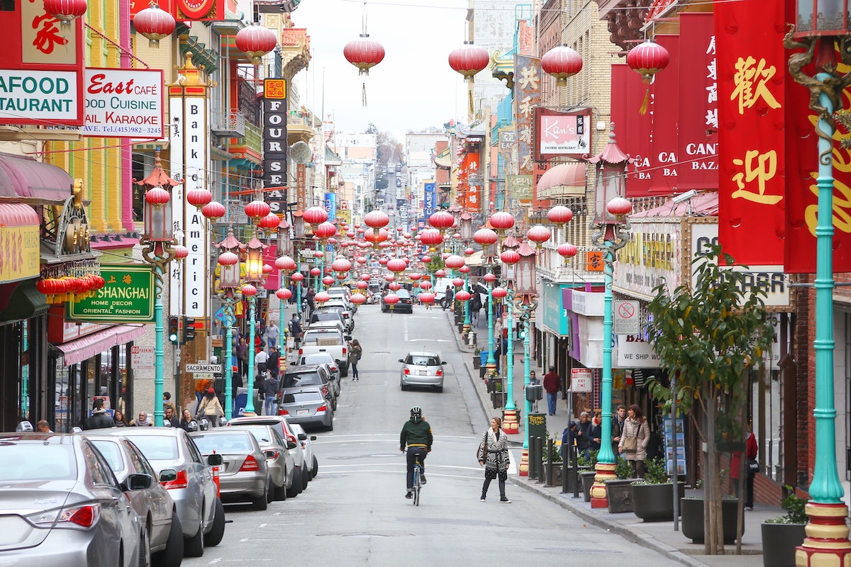 A man cycles down Grant Street, the main street in San Francisco's Chinatown.