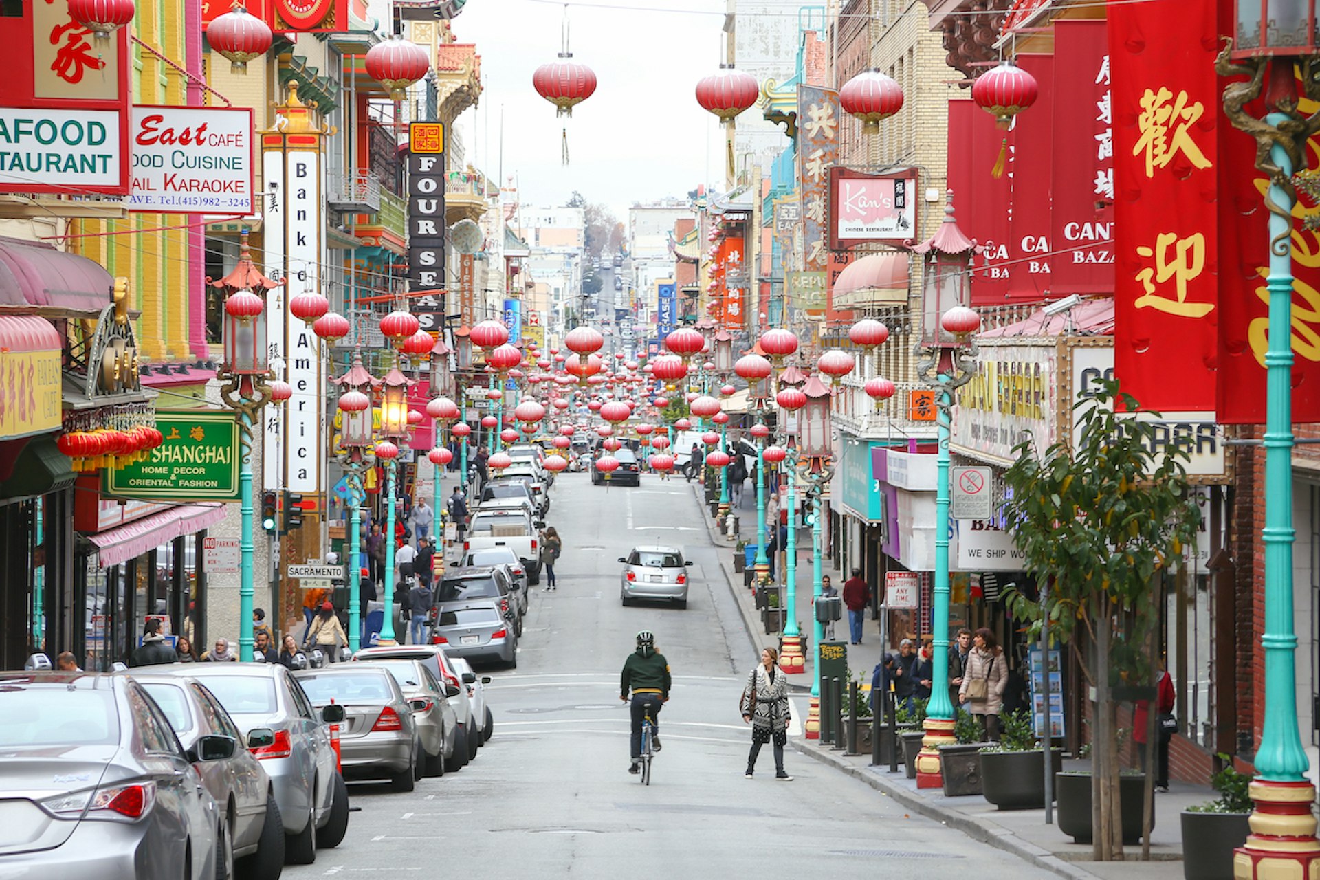 A man bicycles down Grant St in Chinatown, San Francisco, California, USA