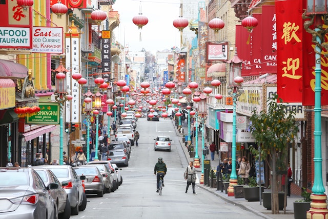 A man cycles down Grant Street, the main street in San Francisco's Chinatown.