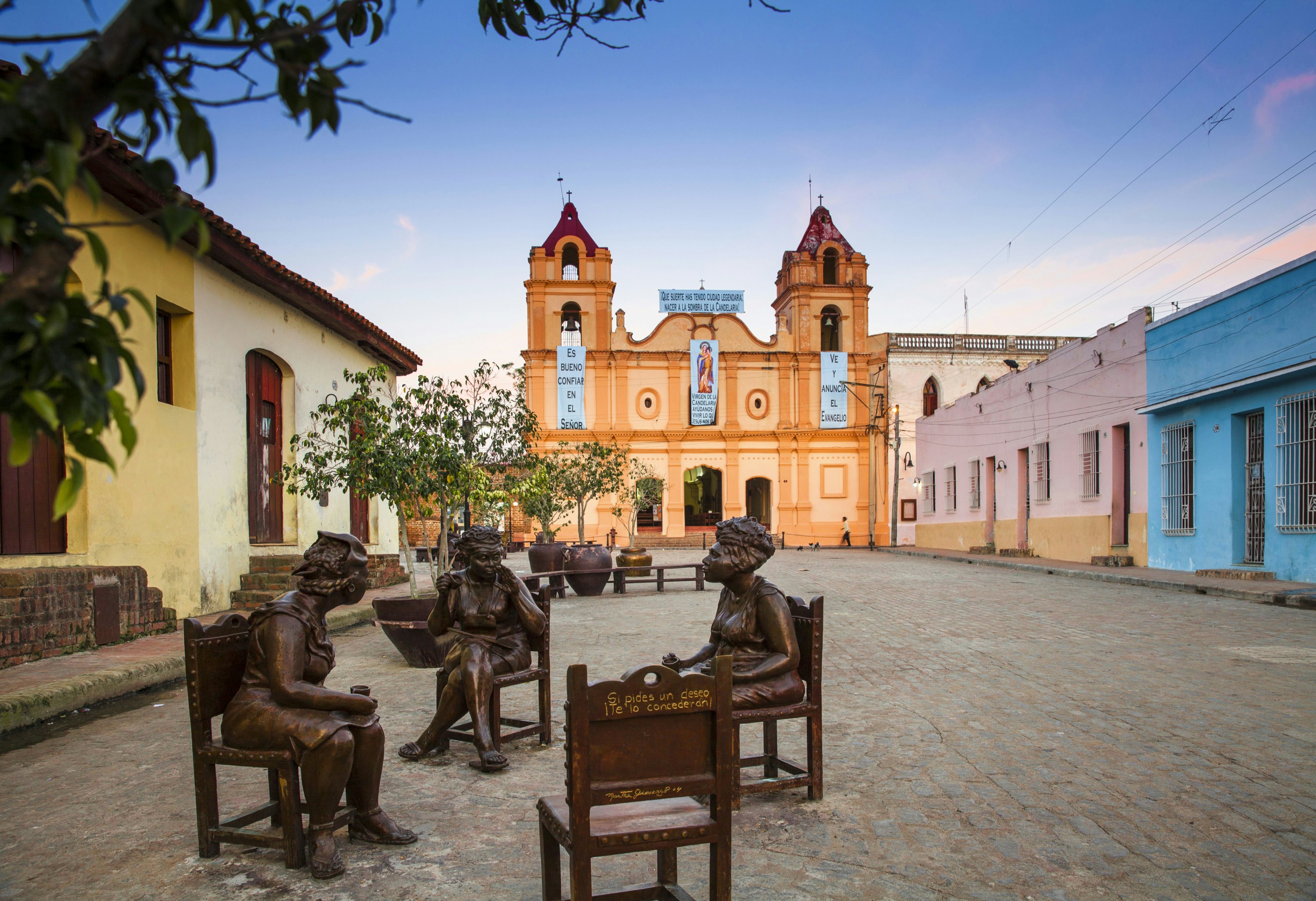 Cuba, Camaguey, Camaguey Province, Plaza Del Carmen, Iglesia de Nuestra Senora del Carmen and Unique life-sized sculptures of camagueyanos going about their daily life
bronze sculpture, christianity, statue, beauty, road, historic district, public square, church, dwelling, bell tower, architecture, dawn, Cuban culture, building, history, everyday scene, nobody, cobblestone, Camaguey, quaint, restored, charming, historic building, place of worship, religious building, sculptural, caribbean island, colonial, grilles, old house, cobbles, caribbean, bronze statue, historic centre, cobbled street, life-size, life-sized, unique, life size, colourful house, window grilles
