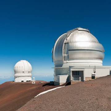 Gemini North Observatory on top of Mauna Kea mountain peak on Big Island of Hawaii, United States with deep blue sky and volcanic landscape.
1327459248