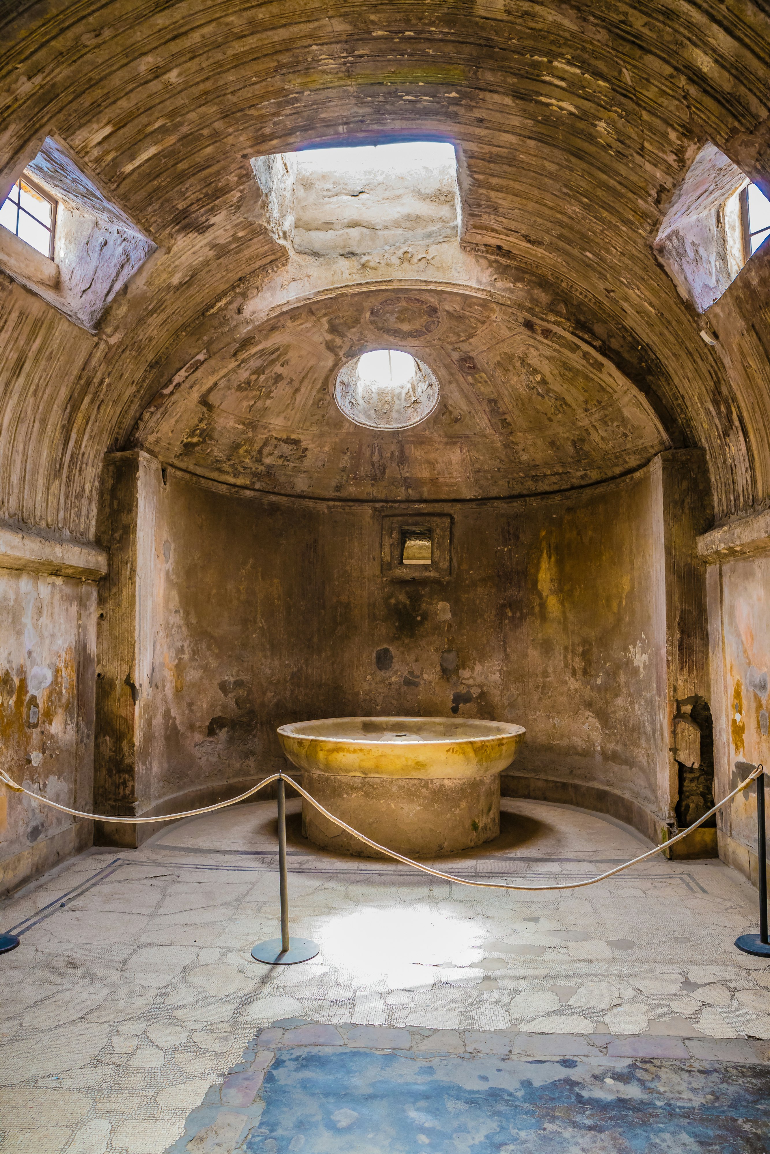 An ancient bathhouse with a domed roof and a round tub