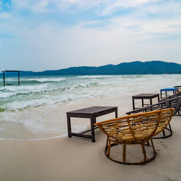 Tables and chairs on the beach in Saracen Bay.