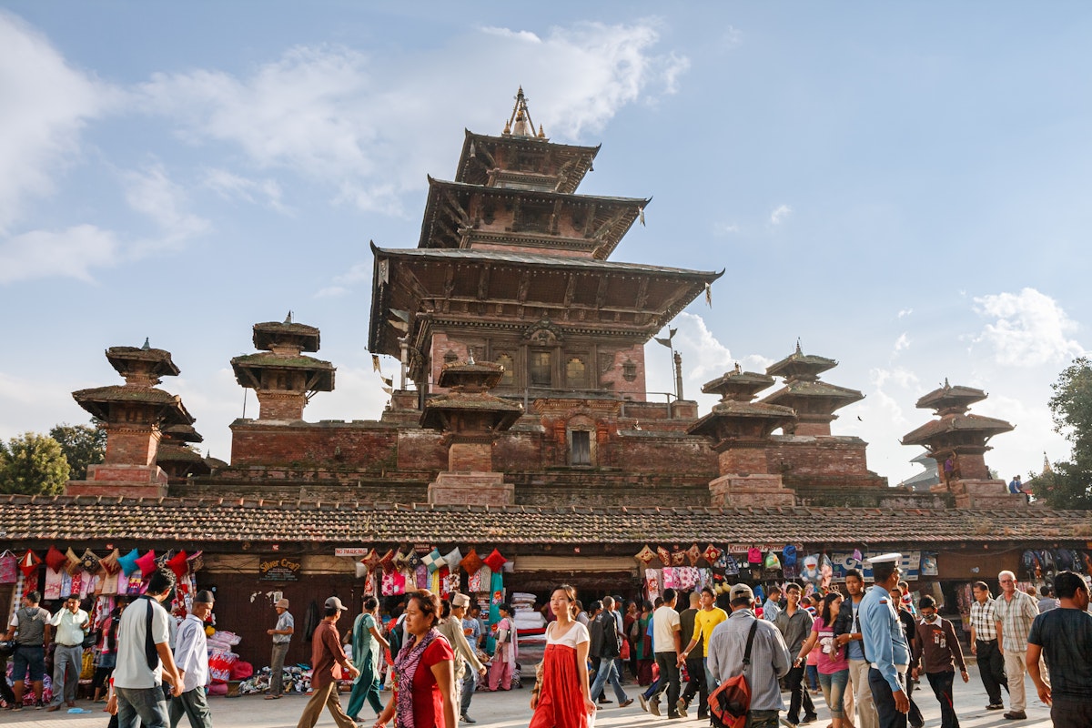 Market and crowds of people at the walls of ancient Taleju Temple on Durbar Square in Kathmandu.