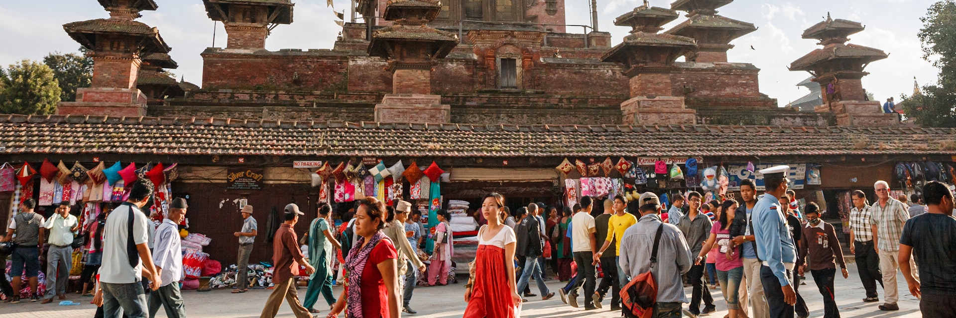 Market and crowds of people at the walls of ancient Taleju Temple on Durbar Square in Kathmandu.