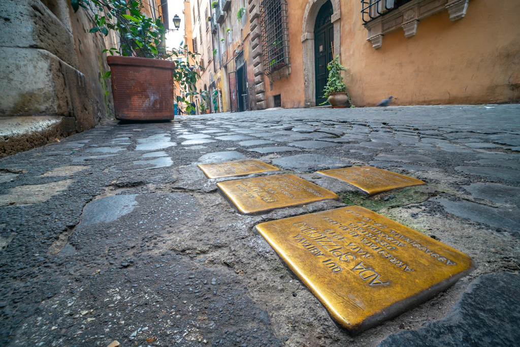 Plaques in the Jewish Ghetto Gold plaques embedded in the cobblestones