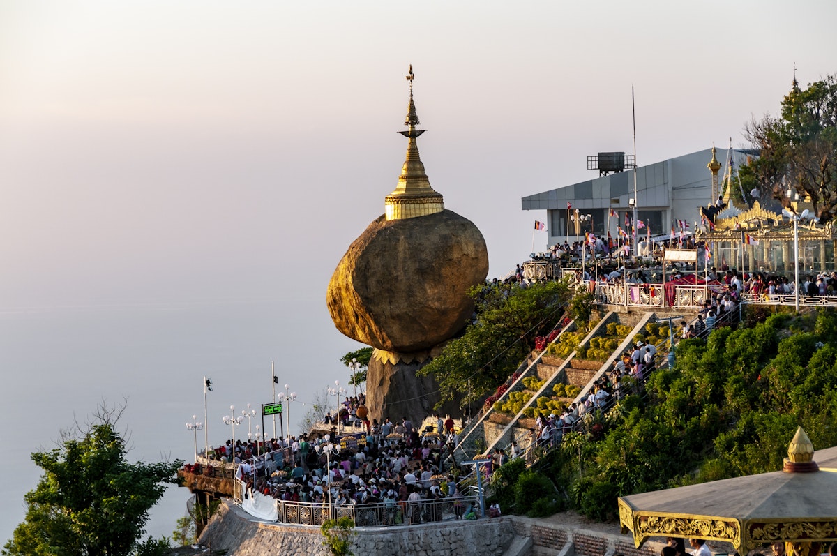 At sunset, hundreds of pilgrims crowd under the Golden Rock, Mt Kyaiktiyo, for the celebrations of the Festival of Lights.