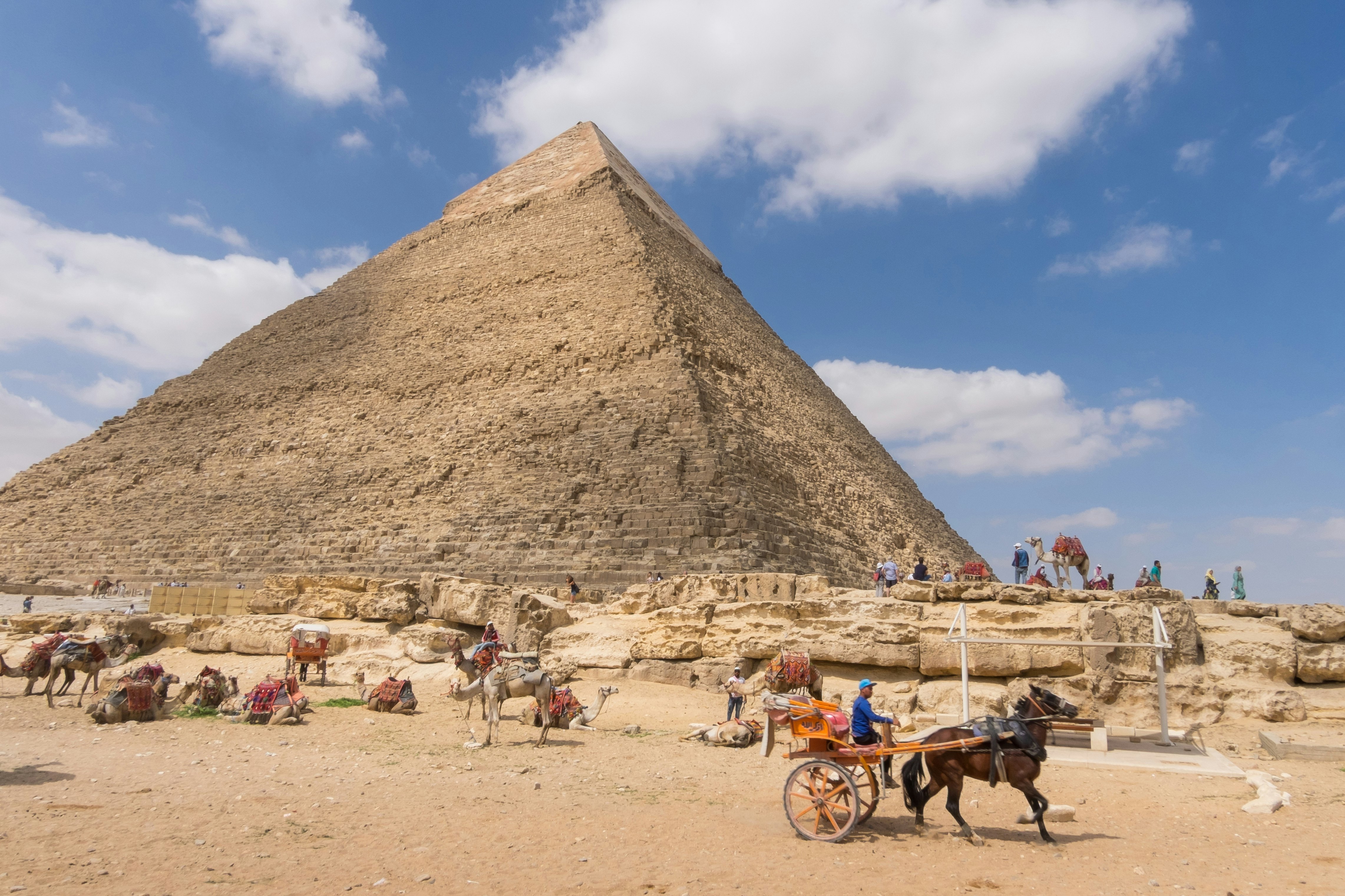 Camels and horse-drawn carriages next to Khafre's pyramid in Giza.