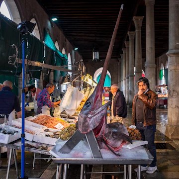 Venice, Italy - 5 April 2016: Fishmongers set up their stalls with a variety of fresh fish, including giant swordfish, at the Rialto fish market, Venice, Italy
519462692
European Culture, Tourism, Men, Fame, Fish Vendor, Color Image, Swordfish, Prepared Fish, Swordfish, Trading, Market Stall, History, Freshness, Colors, International Landmark, Famous Place, Travel Destinations, Urban Scene, Trader, People, Rialto Bridge, Venice - Italy, Italy, Europe, Fish, Market, City, Seafood, Food