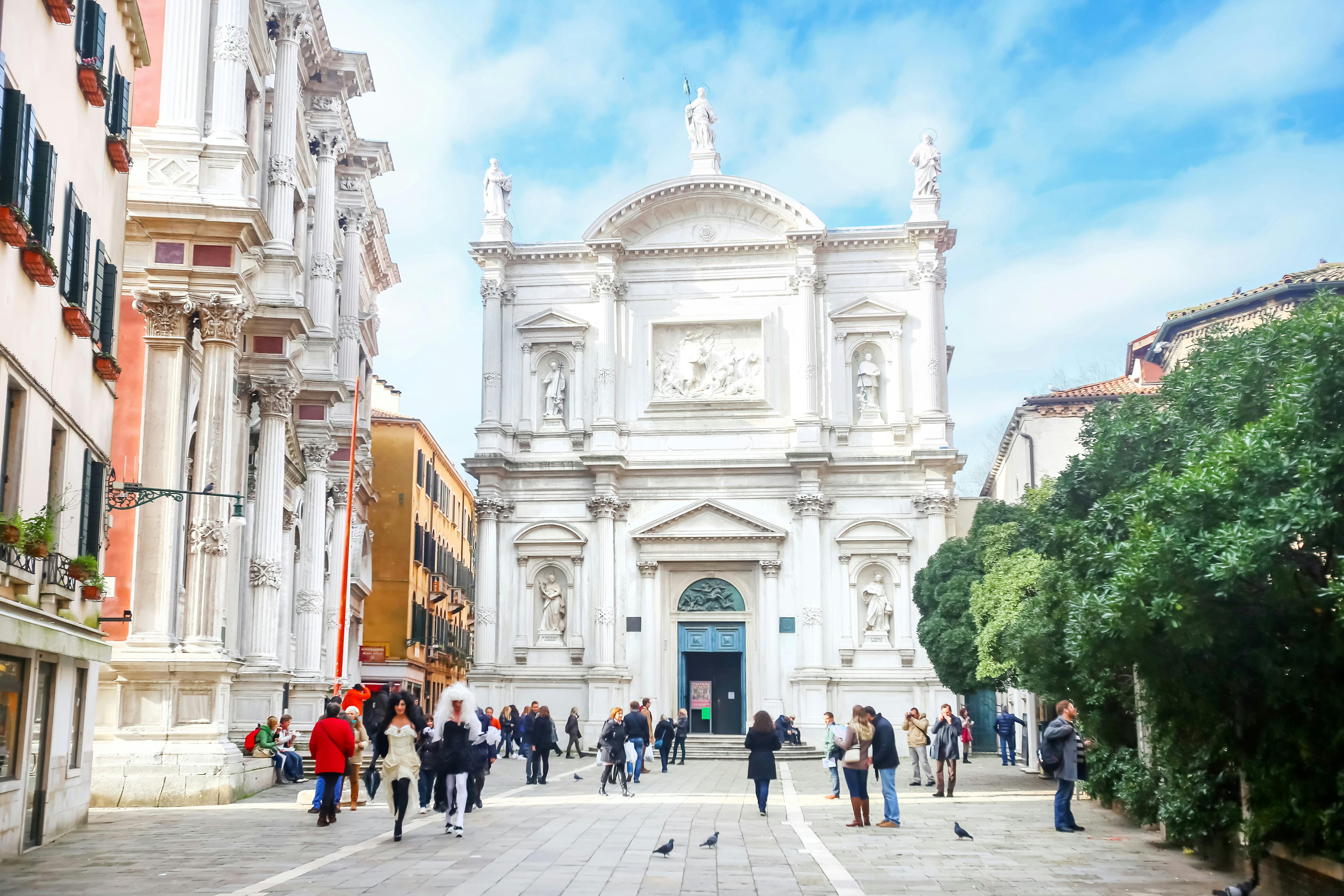 Venice, Italy - February 15th, 2014 : People walking in the square San Rocco in front of a renaissance palace called Scuola Grande di San Rocco in Venice, Italy.
534805231
Editorial, Mediterranean Countries, Travel, Tourism, Photography, Building Exterior, Cloudscape, Large Group Of People, Color Image, Walking, Renaissance, History, White, Green Color, Brown, Blue, Ancient, Old, Cultures, Architecture, Travel Destinations, Vacations, Outdoors, Horizontal, Tourist, People, Venice - Italy, Italy, Europe, Tree, Day, Cloud - Sky, Sky, Town Square, Palace, Built Structure, City, Town, Style, Mediterranean Culture, Scuola Grande Di San Rocco