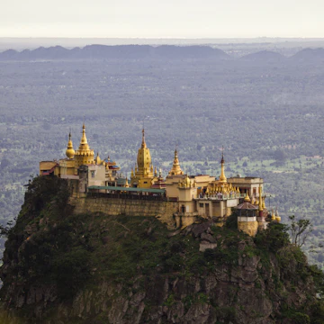 Mount Popa and Taung Kalat of the Mandalay Region, Myanmar. On the foothills of the mountain you will find this beautiful temple perched high up on a hill.