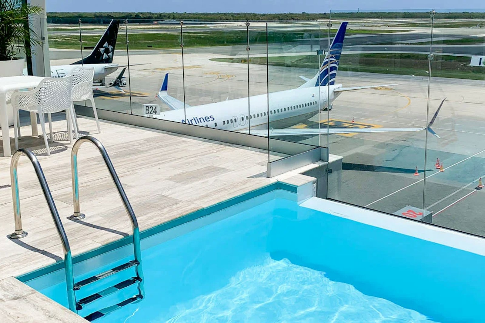The right cards can gain you access to the best lounges, like the Priority Pass lounge in Punta Cana Airport where you can wait to board while wading in a pool