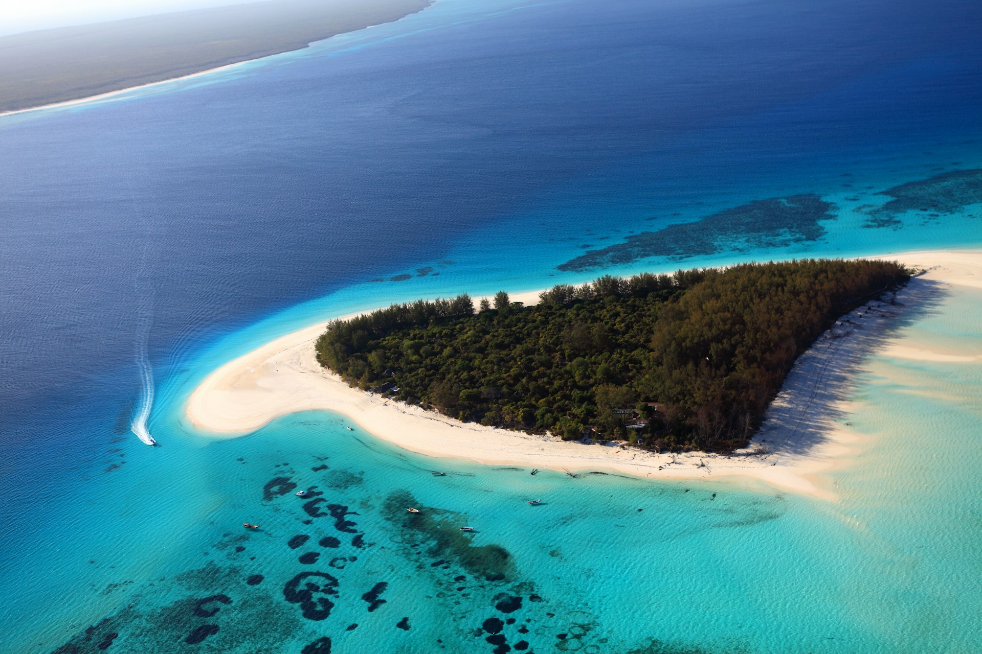 Aerial shot of andBeyond Mnemba Island's fin-shaped coastline