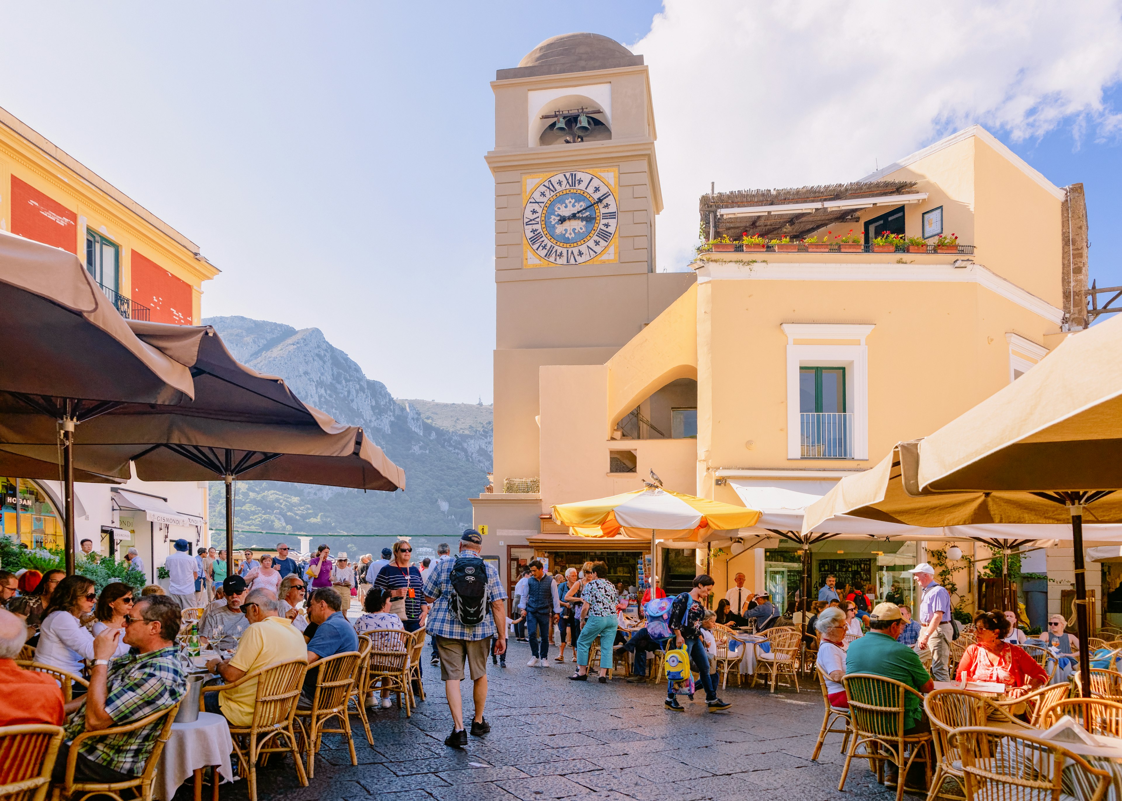 People at Piazza Umberto I Square with Church of Santo Stefano in old town of Capri Island town at Naples, Italy.