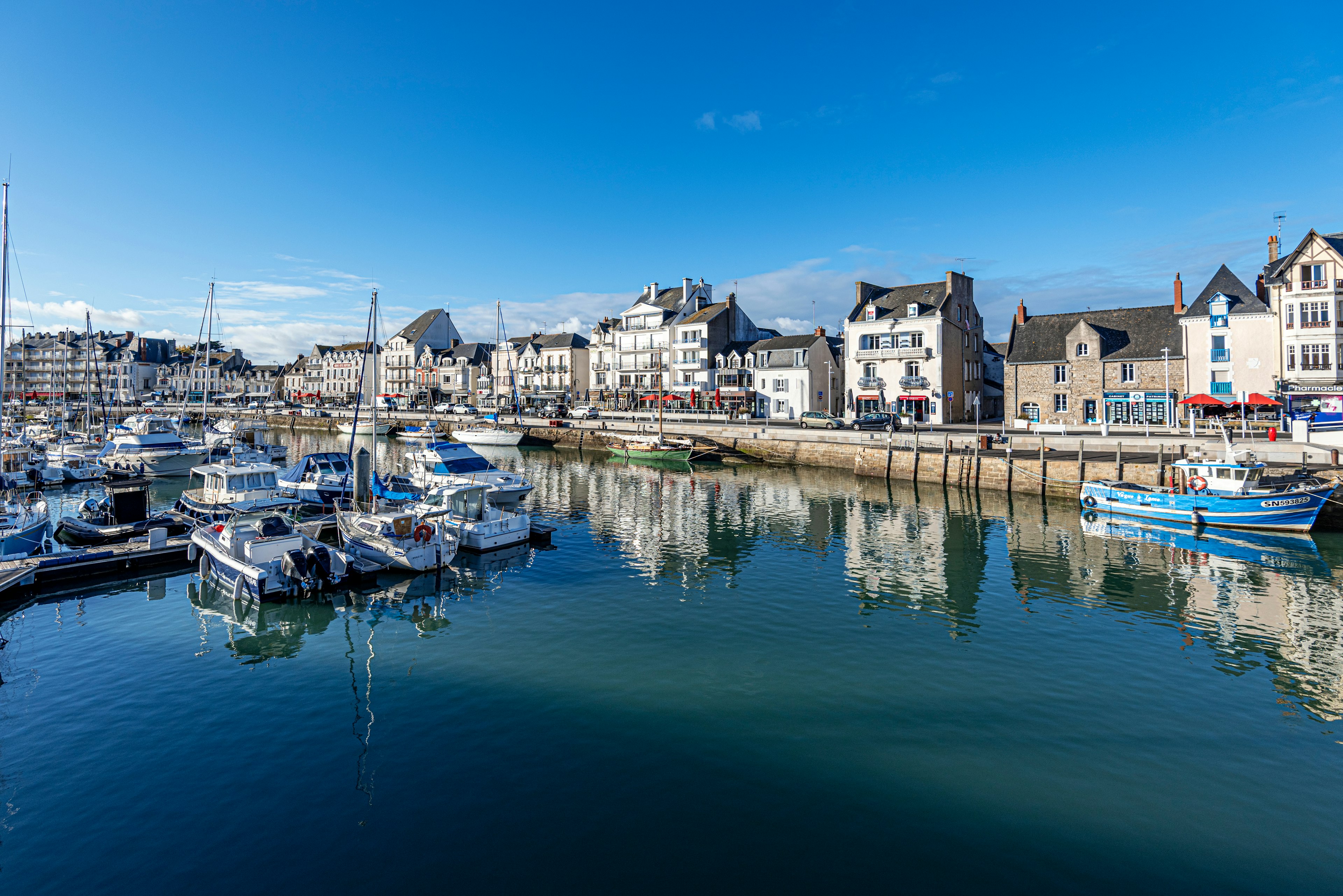 View of Jules Sandeau Quay and boats moored in the port of Le Pouliguen Channel in La Baule, the seaside resort in Southern Brittany.