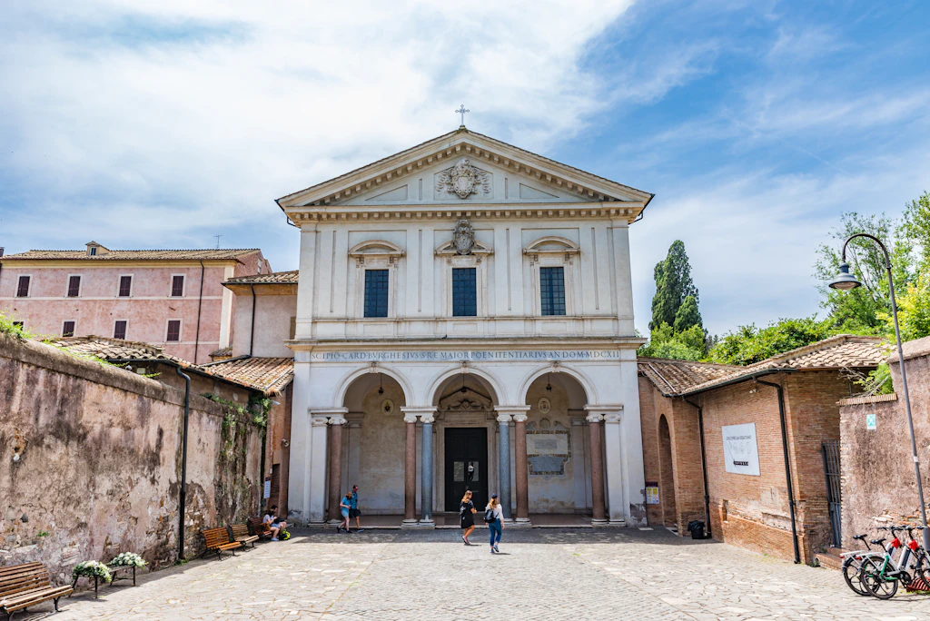 A large white church building, the entrance to catacombs