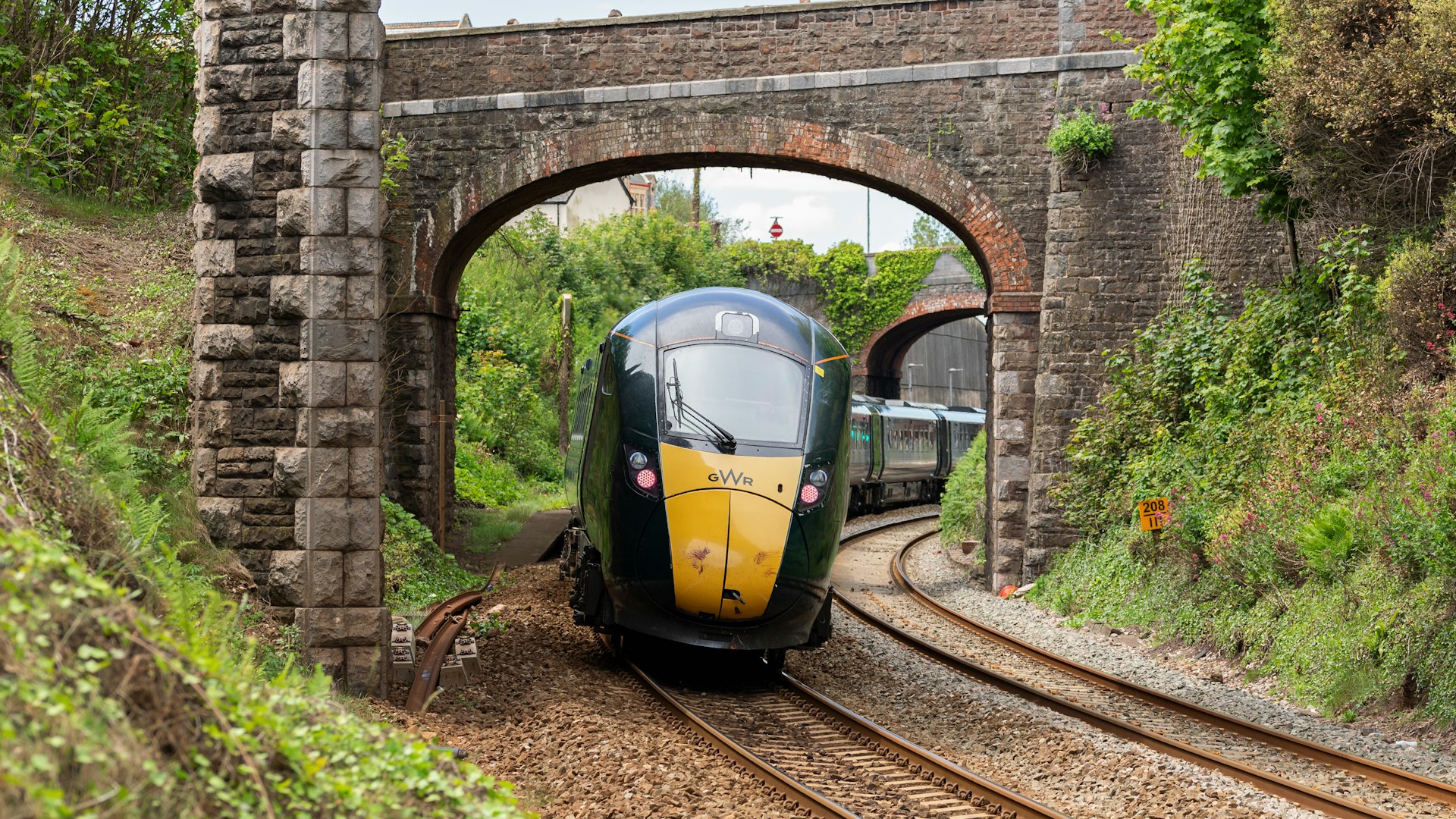 Great Western Railway train under a stone overpass at Teignmouth, Devon, England, UK