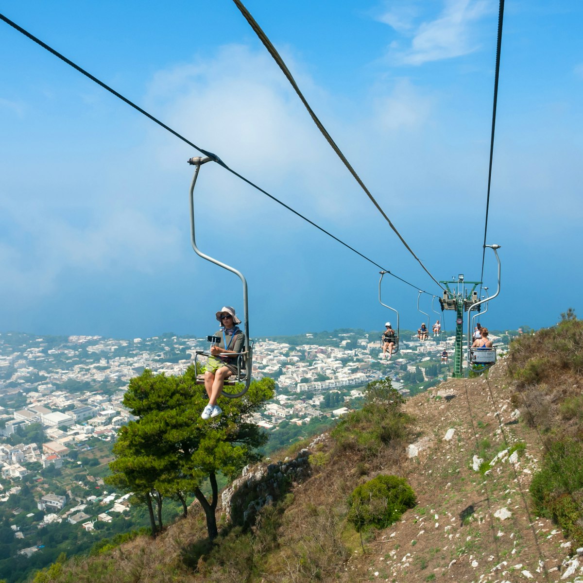 July 29, 2018: People riding up the mountain chair lift in Capri.
1158732217
above, adventure, aerial, amalfi, anacapri, cable, cableway, campania, capri, car, chair, chairlift, city, destination, europe, funicular, height, high, island, italian, italy, landscape, lift, mediterranean, monte, mount, mountain, naples, nature, people, sea, sky, solaro, summer, top, tour, tourism, tourist, touristic, town, transport, transportation, travel, trip, vacation, view, way