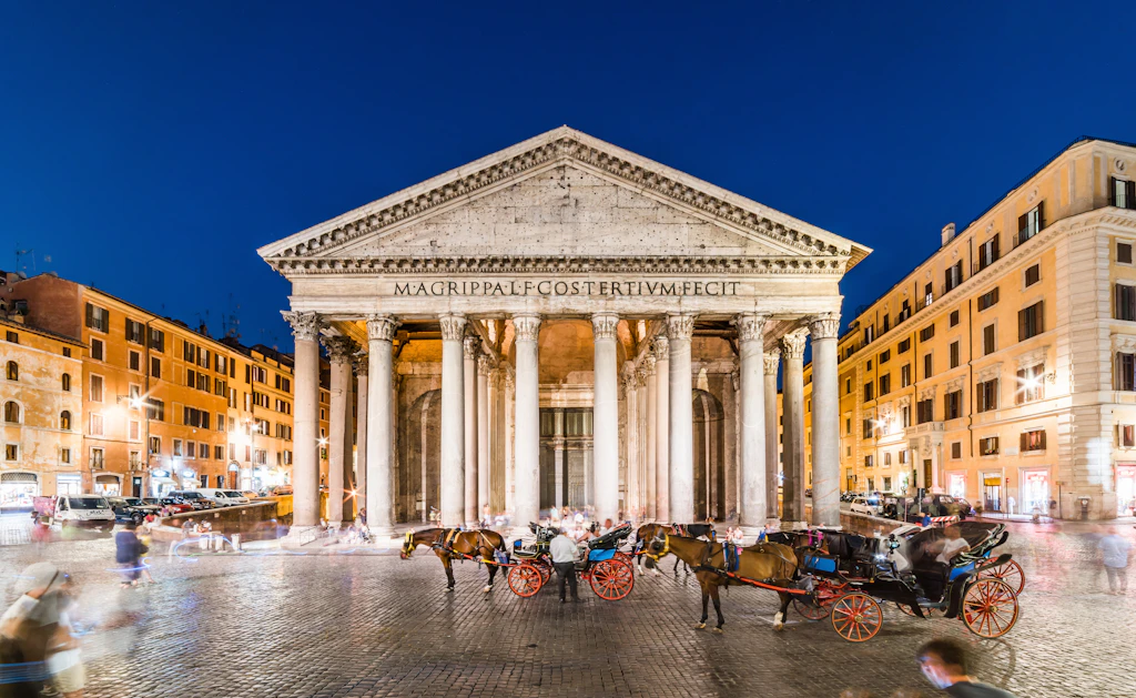 Horse-drawn carriages wait outside an ancient temple building in Rome
